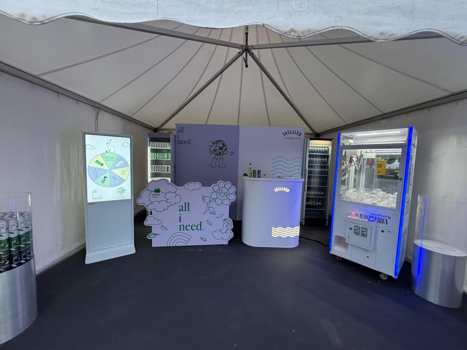 Interior view of the all i need stand with the Spin the Wheel game on screen and chilled iced tea cans
