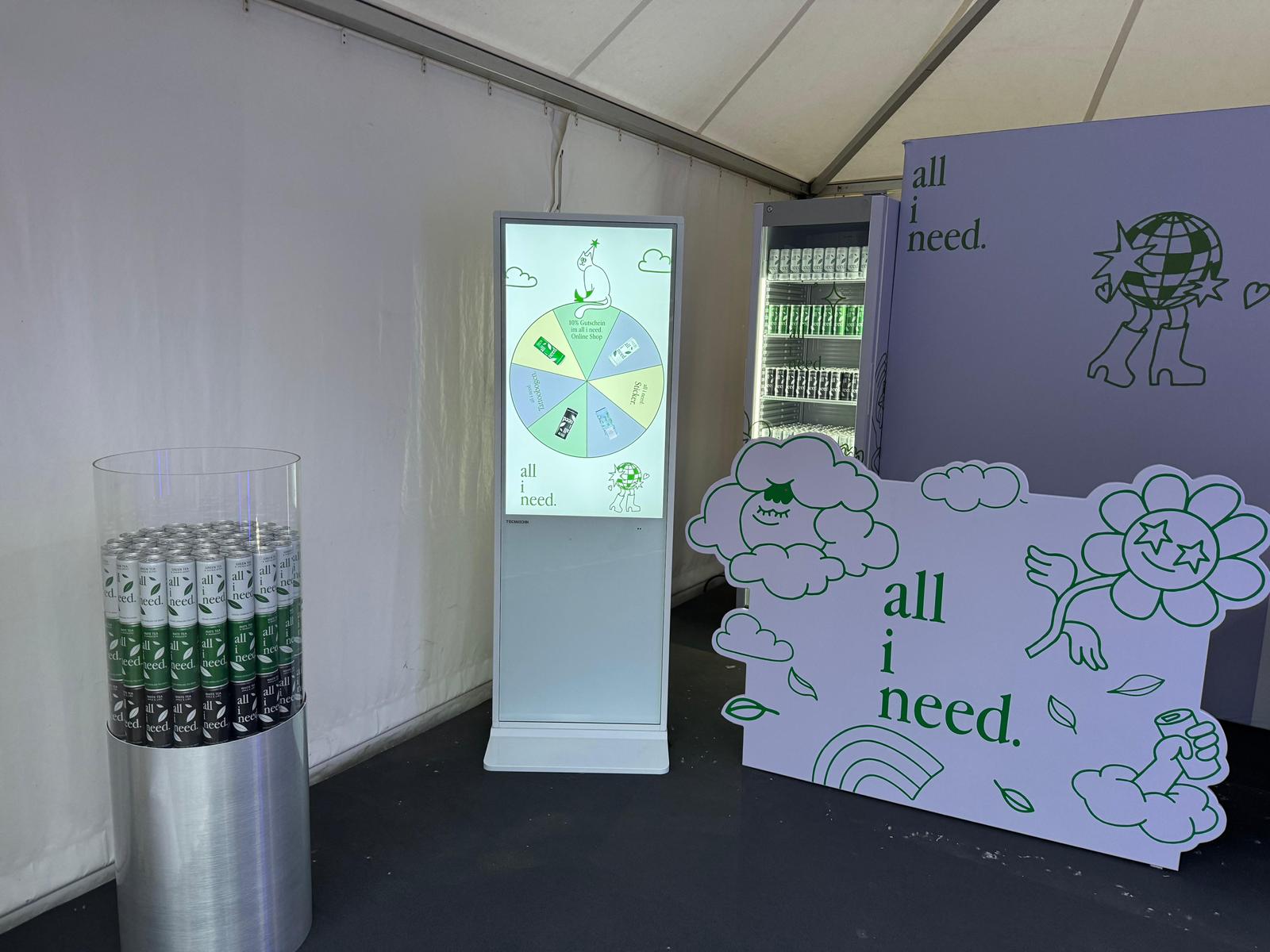 all i need Spin the Wheel game on the digital terminal next to chilled iced tea cans at the stand