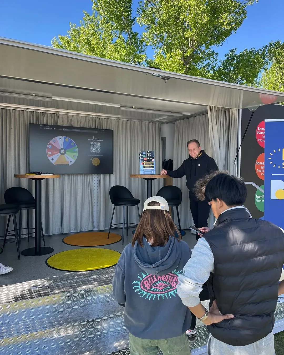 Visitors playing the Burgenland Energie Spin the Wheel game on the screen at the activation stand
